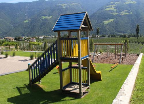 a playground with a slide and a play structure at Residence Fallrohrhof in Naturno