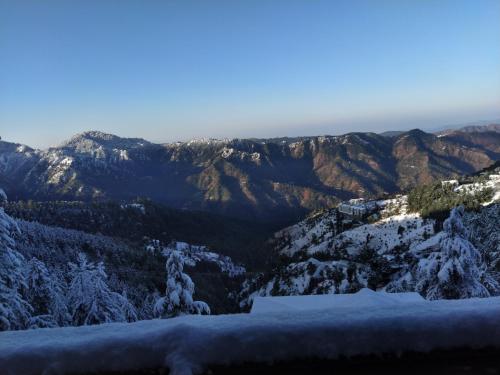 a view from the top of a mountain covered in snow at The Retreat Mashobra, Shimla in Shimla