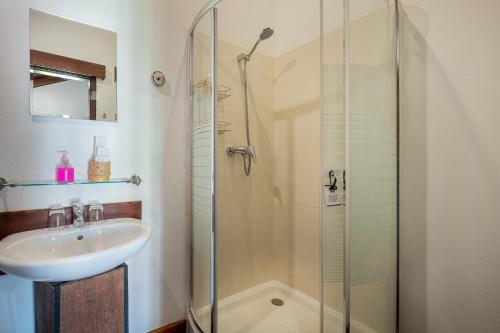 a bathroom with a sink and a shower at Sanctuary Hotel Luang Prabang in Luang Prabang