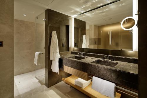 a bathroom with a large sink and a mirror at Four Seasons Hotel Kyoto in Kyoto