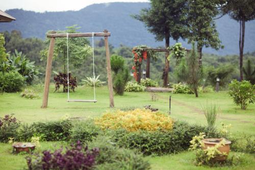 a park with a swing in the middle of a field at Sabaidee Valley in Ban Gnik