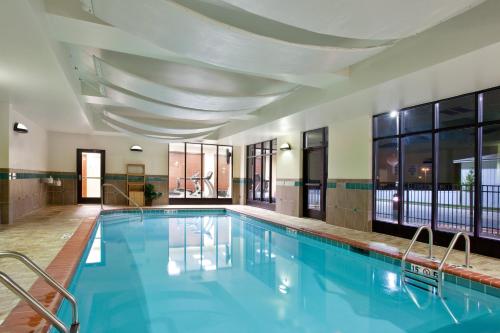 a large swimming pool with blue water in a building at Holiday Inn Saint Louis-Fairview Heights by IHG in Fairview Heights