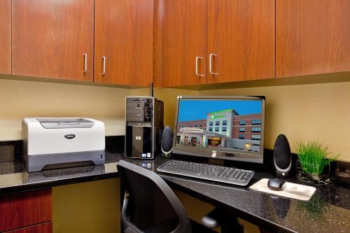 a desk with a computer and a printer on a counter at Holiday Inn Saint Louis-Fairview Heights by IHG in Fairview Heights
