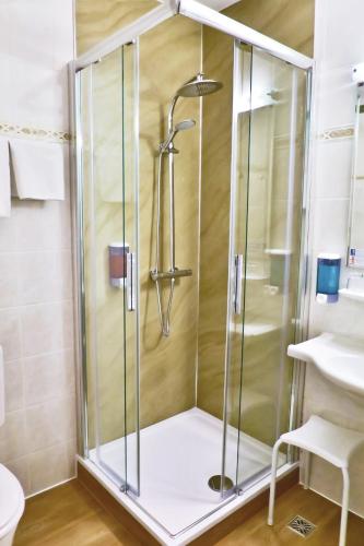 a shower with a glass door in a bathroom at NOVAPARK Flugzeughotel Graz in Graz