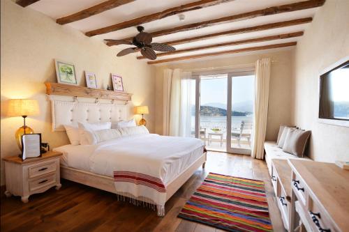 a bedroom with a bed and a large window at Hotel Unique-Boutique Class - Adults Only in Fethiye