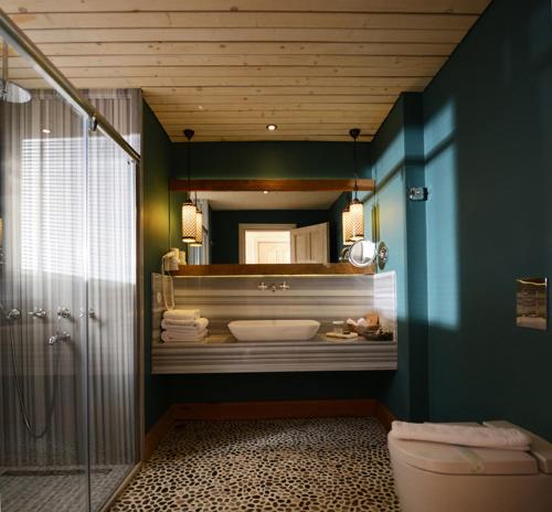 a bathroom with a mirror and a tub and a toilet at Hotel Unique-Boutique Class - Adults Only in Fethiye
