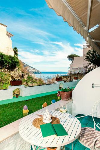 a table on a patio with a view of the ocean at Casa Guadagno in Positano