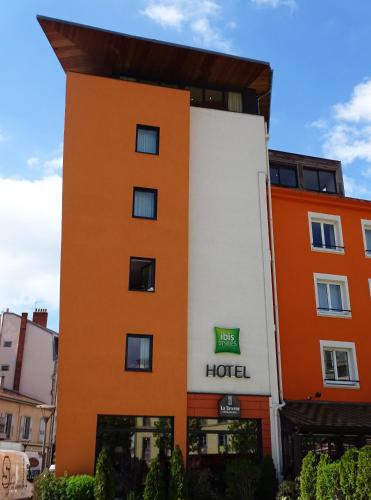 a hotel with an orange and white building at ibis Styles Le Puy en Velay in Le Puy en Velay