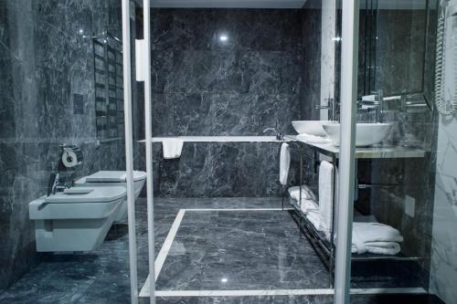 a bathroom with a toilet and a sink at Park Hotel in Dnipro