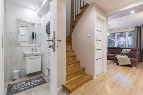 a hallway with a staircase and a living room at Domek IDA Zakopane in Zakopane