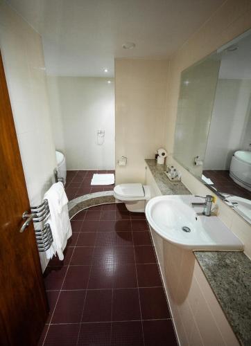 a bathroom with a sink and a toilet at Berwick Manor Hotel in Rainham