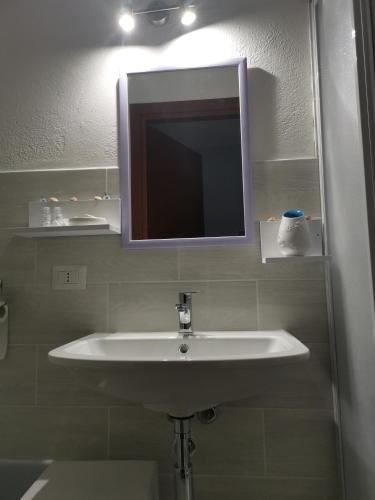 a bathroom with a white sink and a mirror at 4 stagioni in Villasimius
