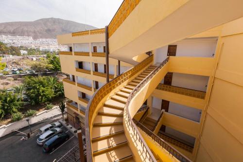a stairway in a building with a view of a city at First line sea, luxury penthouse, sea and sunset view Vivenda Vacational Guayero 618 in Los Cristianos