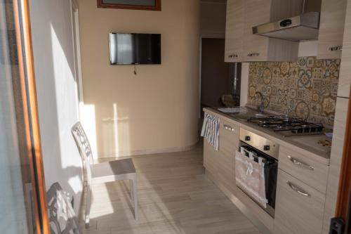 a kitchen with a table and a stove top oven at La rosa dei venti, apartment 2 in Porto Empedocle