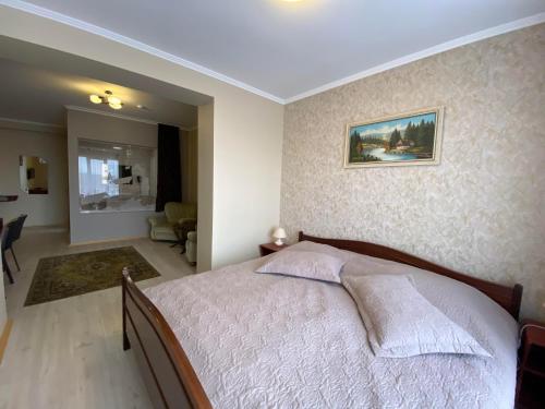 a bedroom with a bed and a living room at Autopark Hotel in Lviv