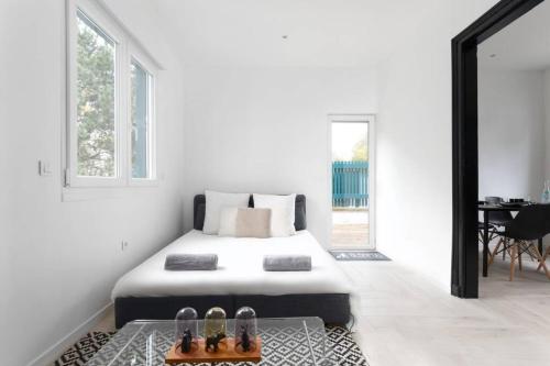 une chambre blanche avec un lit et une table dans l'établissement SLEEPOO - Villa Boheme 7, à Trouville-sur-Mer