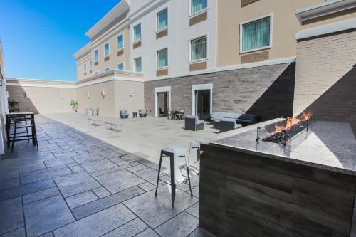 an outdoor patio with a fireplace in front of a building at Holiday Inn Longview - North by IHG in Longview
