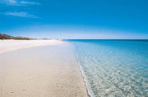 a view of a beach with the sky and water at Sisula Country Hotel & SPA in Orosei