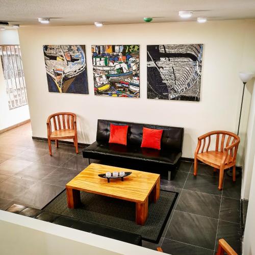 a living room with a couch and two chairs at Apart Hotel Viva Providencia in Santiago
