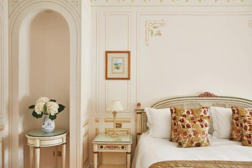 
a bedroom with a bed and a dresser at Splendido, A Belmond Hotel, Portofino in Portofino
