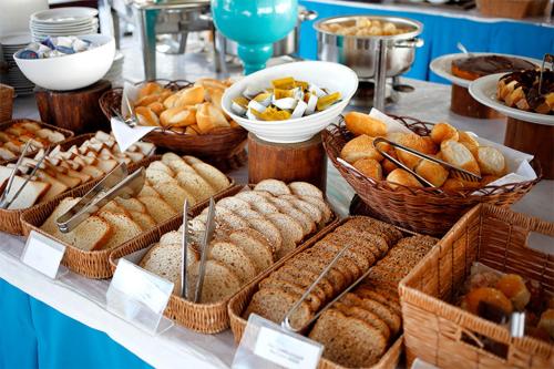 a buffet of bread and pastries on a table at Sisula Country Hotel & SPA in Orosei