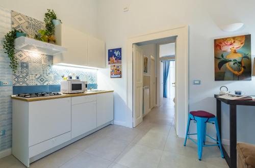 a kitchen with white cabinets and a counter top at Casa Parravano in Caserta