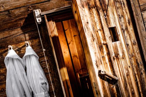 a wooden door with two white towels hanging on it at Caravan Park Sexten in Sesto
