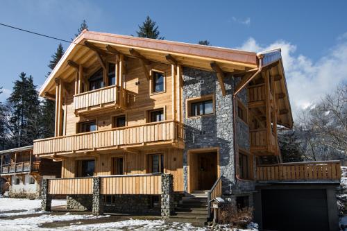 a large wooden house in the snow at Chalet sur les monts Morzine in Montriond