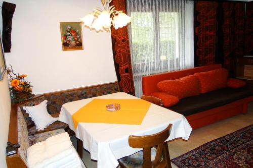 a living room with a table and a couch at Ferienwohnungen Annelies in Tux