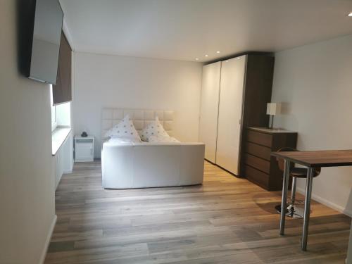 a bedroom with a bed and a table and a desk at Apartment Sofia in Düsseldorf