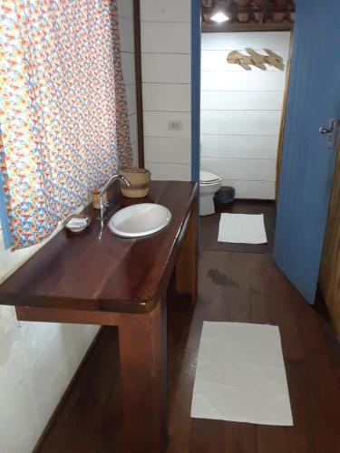 a bathroom with a wooden sink and a mirror at Casinha Amarela EcoLodge Boipeba in Ilha de Boipeba