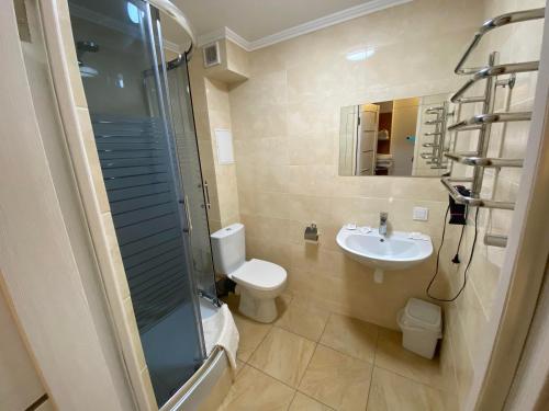 a bathroom with a toilet and a sink and a shower at Autopark Hotel in Lviv