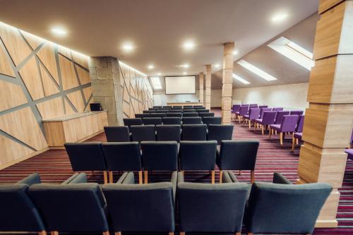 an empty lecture hall with chairs and a screen at Verhovel Hotel in Verkhovyna