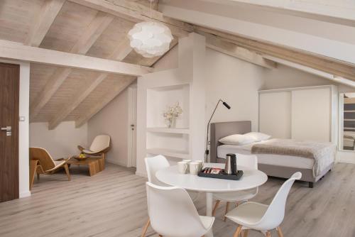 a bedroom with a bed and a table and chairs at Boutique Rooms Mirabilis in Skradin