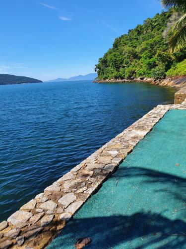 a stone pathway leading into a body of water at Ocean Green Flats in Angra dos Reis