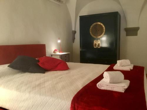 a bedroom with a bed with towels on it at Torre Guinigi Luxury Loft nel centro storico di Lucca in Lucca