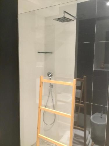 a bathroom with a shower with a glass door at Torre Guinigi Luxury Loft nel centro storico di Lucca in Lucca