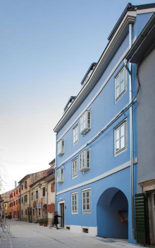 a blue building on the side of a street at Boutique Rooms Mirabilis in Skradin