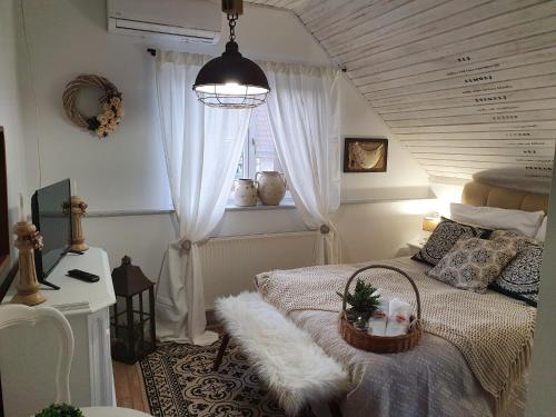 Un dormitorio con una cama con una cesta. en Gasthaus Joó-Wellness Pension en Rábapaty