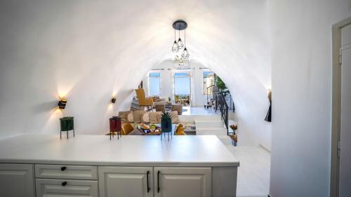 a kitchen with an archway and a living room at PLAZAsuite1600 in Rethymno