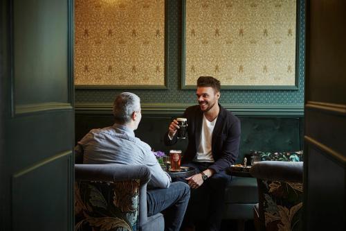 two men sitting in a bar drinking at The Hardiman in Galway