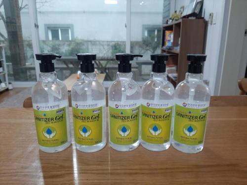 a group of four bottles of water sitting on a table at Byulbam Guesthouse in Gwangju