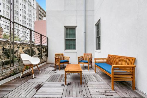 a row of chairs and a table on a balcony at 1 and 2 BR Private Condos Steps Away From French Quarter in New Orleans