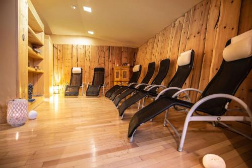 a row of chairs in a room with wooden walls at Veronza Clubresidence in Cavalese