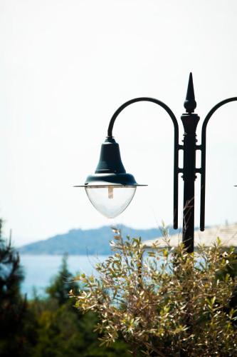 a street light with a view of the water at Ayia Marina Suites in Ouranoupoli
