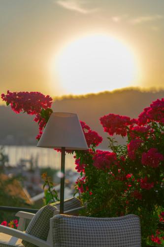 a lamp sitting on top of a table with flowers at Hotel Unique-Boutique Class - Adults Only in Fethiye