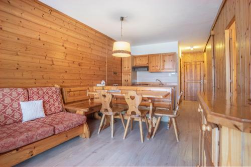 a kitchen and dining room with a table and a couch at Veronza Clubresidence in Cavalese