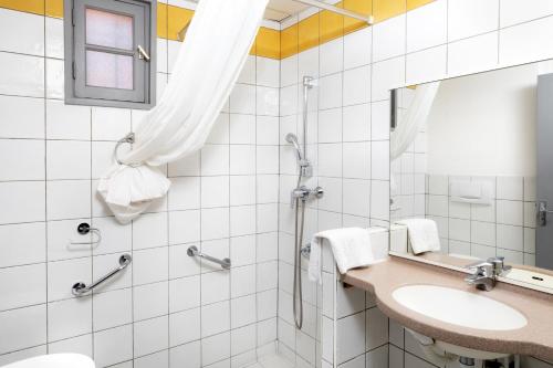 a bathroom with a sink and a shower at SOWELL RESIDENCES Chênes Verts in Saint-Raphaël