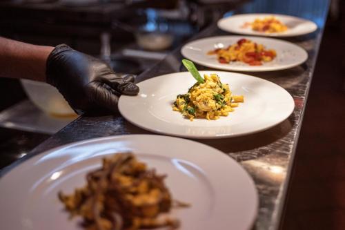 a table with plates of food on a counter at Veronza Clubresidence in Cavalese