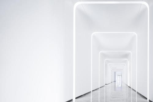 an empty corridor with white walls and a white hallway at FlyZoo Hotel - Alibaba Future Hotel in Hangzhou
